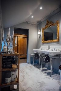 a bathroom with two sinks and a mirror at Ripple Cottage in Ripple