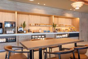 a restaurant with a table and chairs in a kitchen at B&B HOTEL Vila do Conde in Vila do Conde