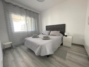 a bedroom with a large bed and a window at Newly renovated apartment with 2 terrace, 2 bedroom, 5min beach in Puerto de Santiago
