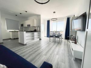 a living room with a kitchen and a dining room at Newly renovated apartment with 2 terrace, 2 bedroom, 5min beach in Puerto de Santiago