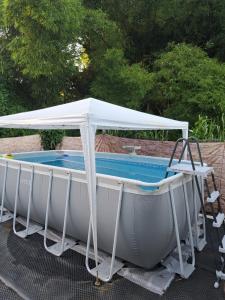 een witte boot met een luifel boven een zwembad bij Villa in Baie Mahault
