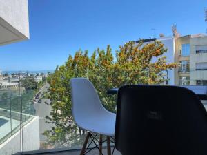 a chair sitting on a balcony with a view of a city at Glamorous Habous - By AppartAli in Casablanca