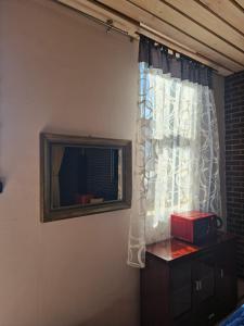 a bedroom with a window with a radio on a table at WILLA VASCO ADMIRAŁ in Rewa