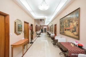 a corridor of a hospital with tables and chairs at Regent Hotel in Mumbai