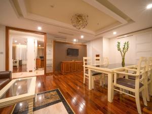 a dining room with a table and chairs and a television at Samdi Da Nang Airport Hotel in Danang