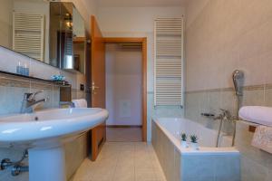 a bathroom with a sink and a bath tub and a sink at Parco del Velodromo Comfortable Apartment in Bologna