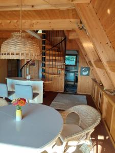 a dining room with a white table and chairs at Haus am See Willingen in Willingen