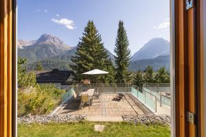 a view from a window of a patio with mountains at Arch San Martin C in Scuol