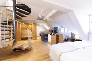 a bedroom with a staircase and a living room at Gasthof Zufriedenheit in Naumburg