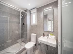 a bathroom with a toilet and a sink and a shower at Waterman Beach Village in Supetar +23 photos