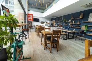 a restaurant with wooden tables and chairs and a counter at Family 3 Bed Loft @Cantonments in Cantonments