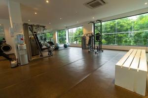 a room with a gym with machines and windows at Family 3 Bed Loft @Cantonments in Cantonments