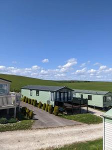 a row of mobile homes on a road at Caravan - Sleeps 6 - Sea Views - Dog Friendly in Flamborough