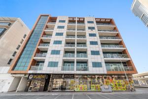 a tall building with a store in front of it at Silkhaus Modern Living Studio in Art Residence in Dubai