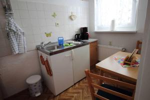 a small kitchen with a sink and a table at Ferienwohnung Thurk in Sassnitz