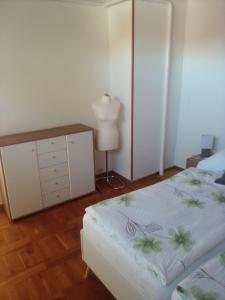 a bedroom with a bed and a dresser and a lamp at Ferienwohnung Straßburg in Sassnitz