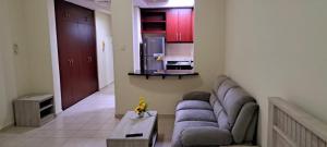 a living room with a couch and a table at Studio flat DG079, Close to The Gardens Metro 3 min walkable in Dubai