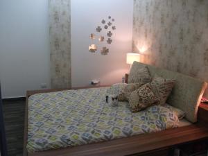 a bedroom with a bed and pillows on it at Chalet Siwar resort, pool, wifi, sea view, electricity 247, 2 bedrooms, 87sqm in Dbayeh