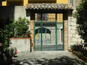 einen Eingang zu einem Gebäude mit grünem Tor in der Unterkunft Casa Vela in Ariano Irpino