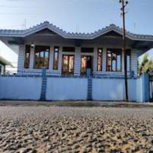 a house on the side of a street with a house at VIbe n Joy Homestay in Cherrapunji