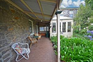 a patio with chairs and tables on a house at Victoria House in Portland