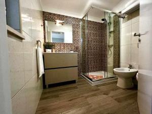 a bathroom with a shower and a sink and a toilet at Green House by FHR estacionamento e WI-FI in Quarteira +14 photos