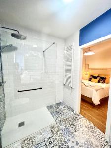 a bathroom with a shower and a bed at SolGredos I in Arenas de San Pedro