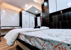 a bedroom with a large bed and a large window at Staeg Villa in the Center of the City 2BHK in Indore