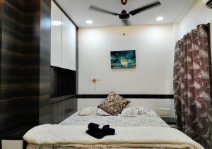 a bedroom with two beds and a ceiling fan at Staeg Villa in the Center of the City 2BHK in Indore