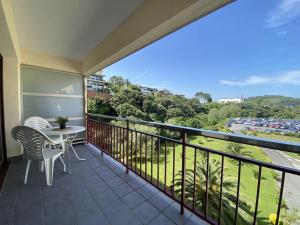 a balcony with a table and chairs and a view at Gorliz Beach House in Górliz-Elexalde