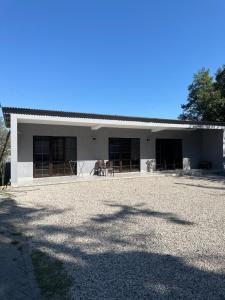 a house with a large driveway in front of it at Отель Гудоу in Gudauta