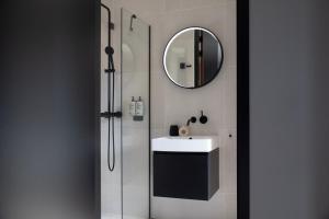 a bathroom with a sink and a mirror at Bob W Amsterdam Noord in Amsterdam