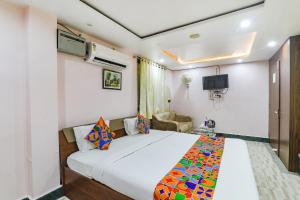 a bedroom with a large white bed in a room at FabHotel Astor in Gaya