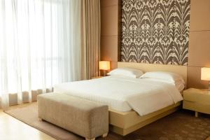 a bedroom with a bed and a large window at Hyatt Regency Dushanbe in Dushanbe