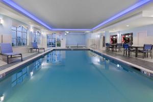 a large pool with blue water in a building at Homewood Suites by Hilton Boston/Canton, MA in Canton