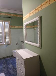 a bathroom with a sink and a mirror on the wall at Casa della Ludo B&B in SantʼAntonino