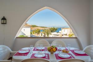 a dining room with a table with a view of the ocean at Villa Sharon in L'Escala
