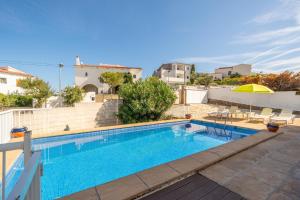 a swimming pool on the roof of a house at Villa Sharon in L'Escala