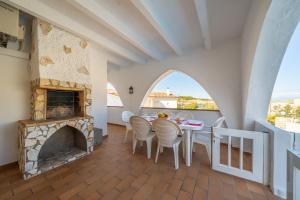 a living room with a table and a fireplace at Villa Sharon in L'Escala