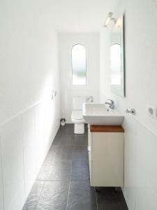 a white bathroom with a sink and a toilet at Villa Sharon in L'Escala +13 photos