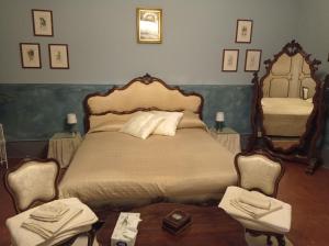 a bedroom with a large bed and a mirror at Casa della Ludo B&B in SantʼAntonino