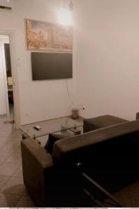 a living room with a couch and a tv on the wall at Borgo’s app in Bologna