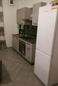a kitchen with a white refrigerator and a stove at Borgo’s app in Bologna