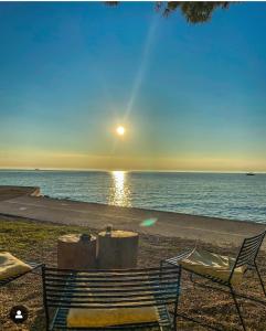 a bench on the beach with the sun setting over the ocean at Nice vacation in Poreč