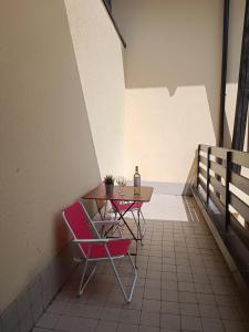 a table with two chairs and two bottles on it at OHANA APARTMENT in Passo del Tonale