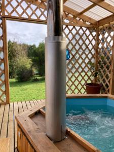 una piscina en un pabellón con una fuente de agua en El Viloche - Casa de campo con tinaja, en Puerto Montt