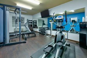 a gym with treadmills and machines in a room at Comfort Suites Arlington - Entertainment District in Arlington