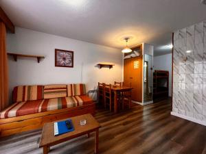 a living room with a couch and a table at Frontera Blanca in Pas de la Casa
