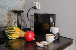 a counter with two cups of coffee and a fruit at Maya's Flats & Resorts 34 - Chmielna 73 in Gdańsk