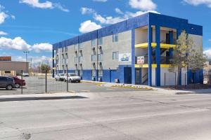 a blue and gray building with a parking lot at Days-Inn by Wyndham Albuquerque I-25 in Albuquerque